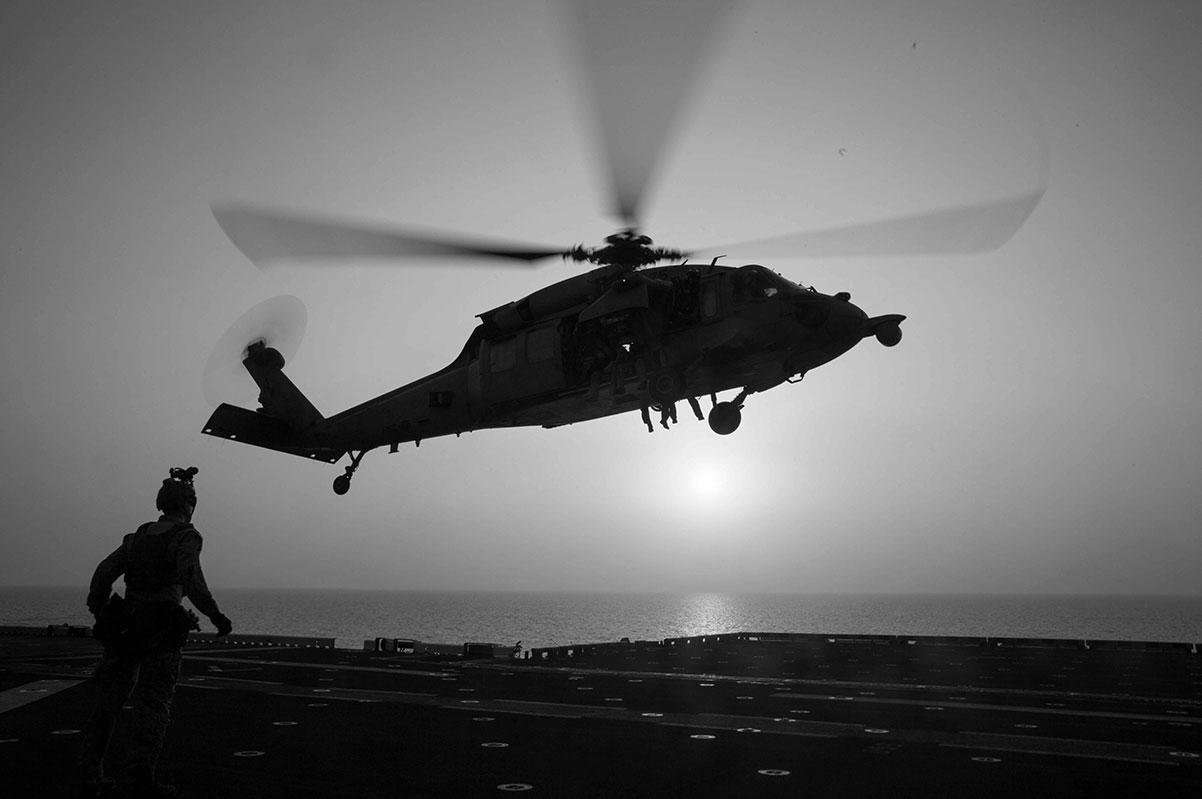 Helicopter lifting off from an aircraft carrier